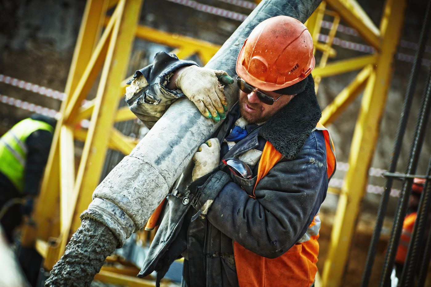 Construction worker placing concrete on site